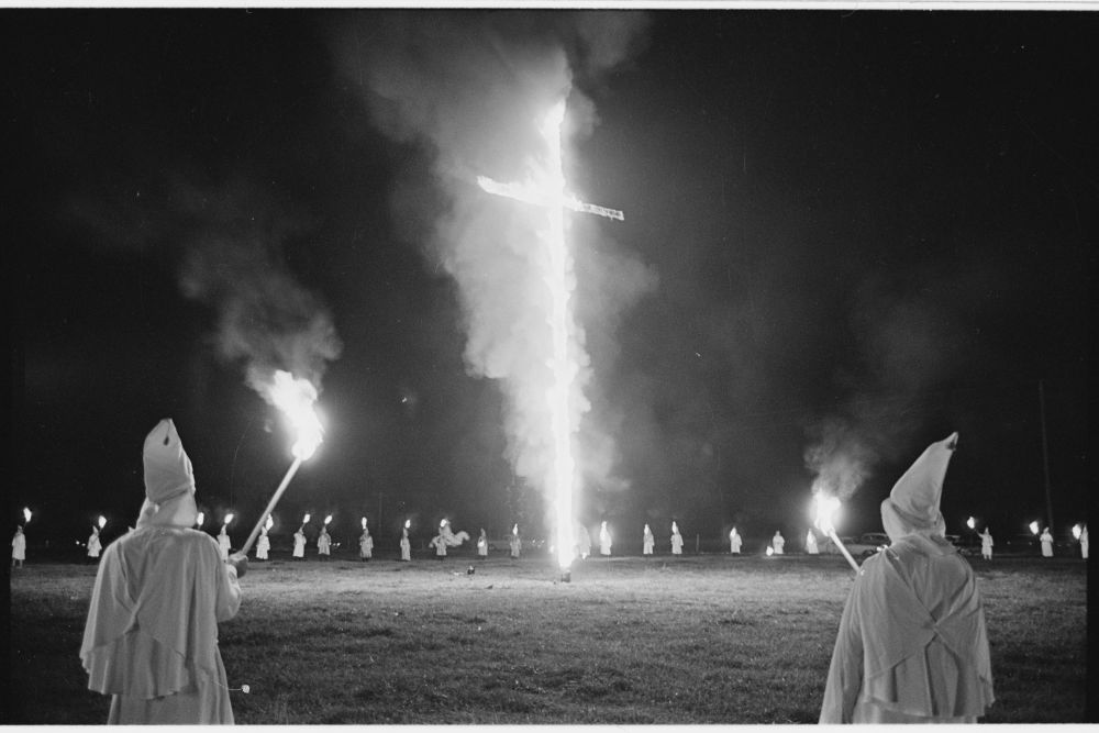 Huge Ku Klux Klan rally in Salisbury, Klan members circled about a blazing cross, Don Sturkey